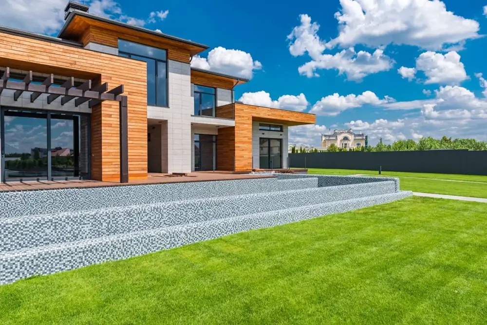 House with tall glass patio doors opening onto a terrace